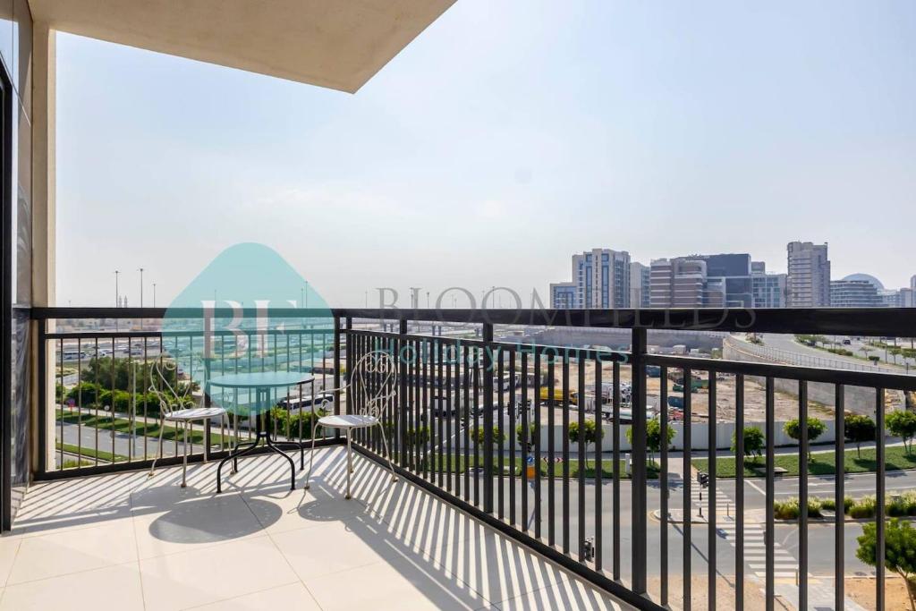 a balcony with a view of the city at Bloomfields Cozy Stu In The View Raha Beach in Abu Dhabi