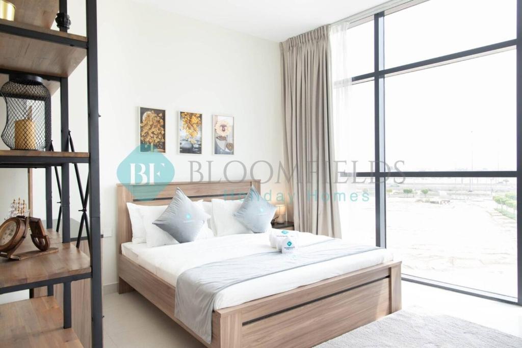 a bedroom with a bed and a large window at Bloomfields Artistic Stu In The View Raha Beach in Abu Dhabi