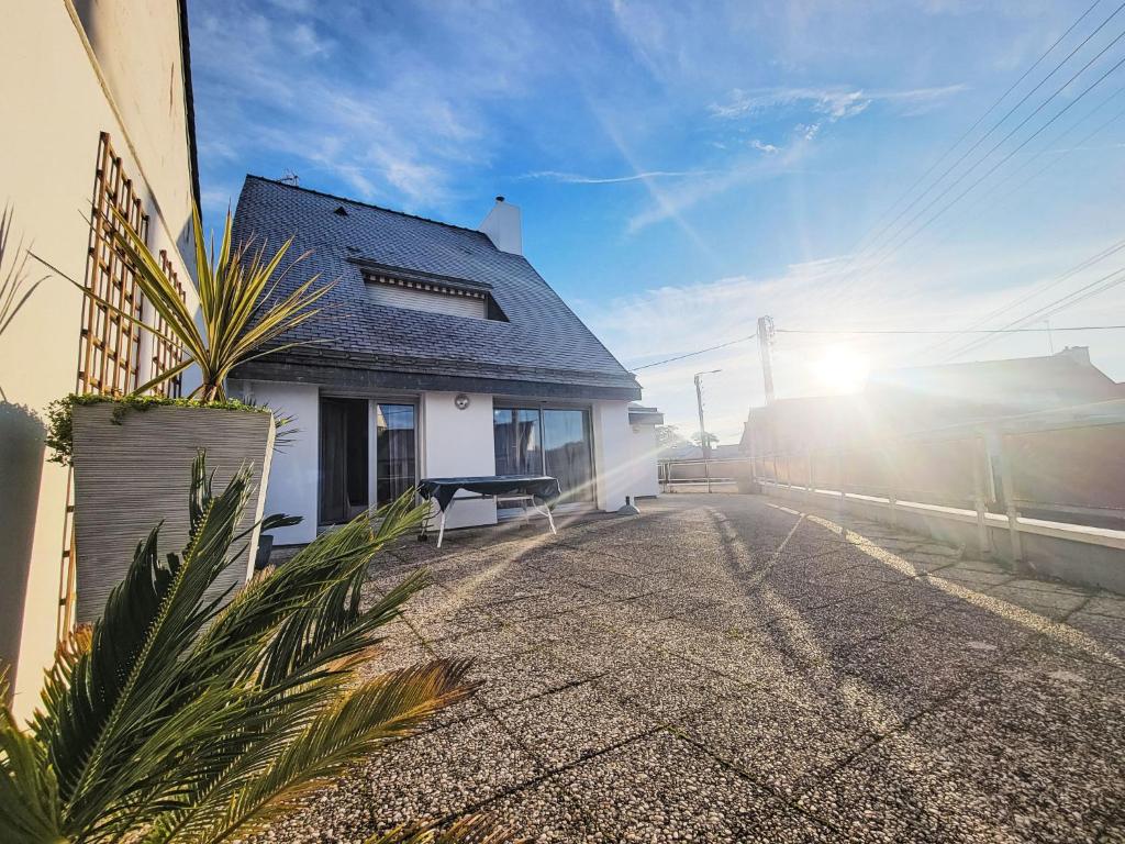 a white house with the sun in the sky at Apartment Les Embruns-2 by Interhome in Carnac