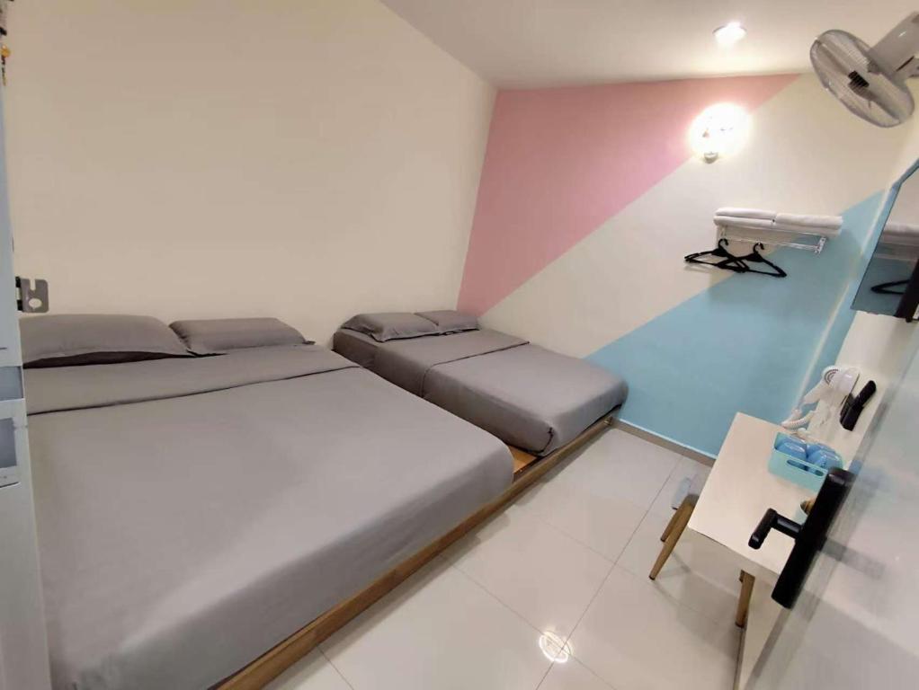 Postel nebo postele na pokoji v ubytování MUSANG ONG HOTEL