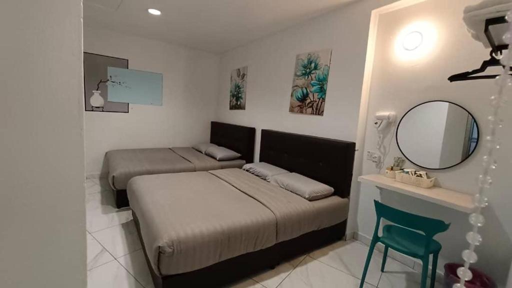 Postel nebo postele na pokoji v ubytování MUSANG ONG HOTEL