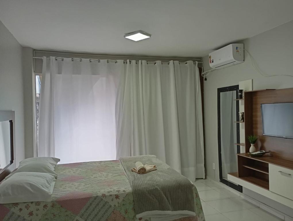a bedroom with a bed and a large window at Apto 348 centro nucleo bandeirante in Núcleo Bandeirante