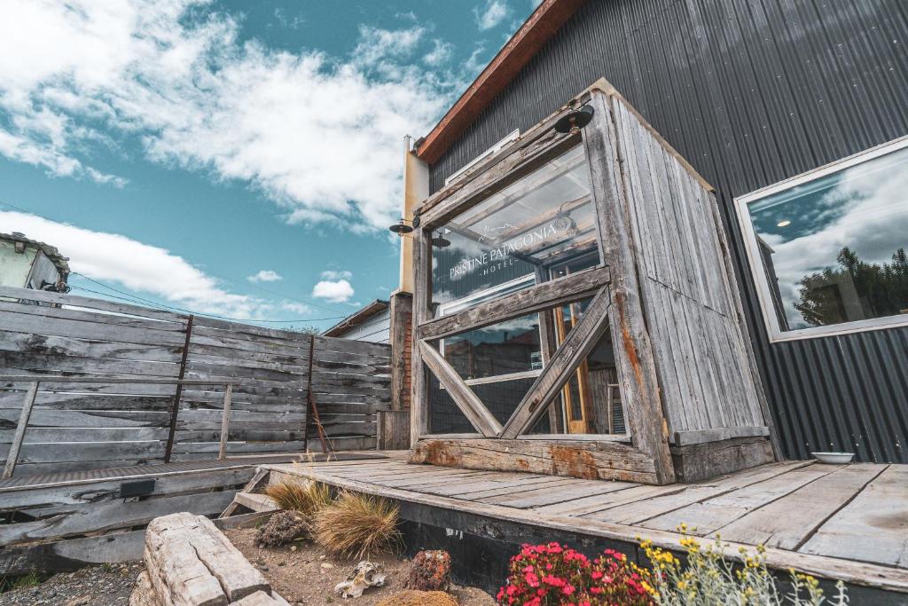 a wooden door on the side of a building at Pristine Patagonia Hotel in Puerto Natales