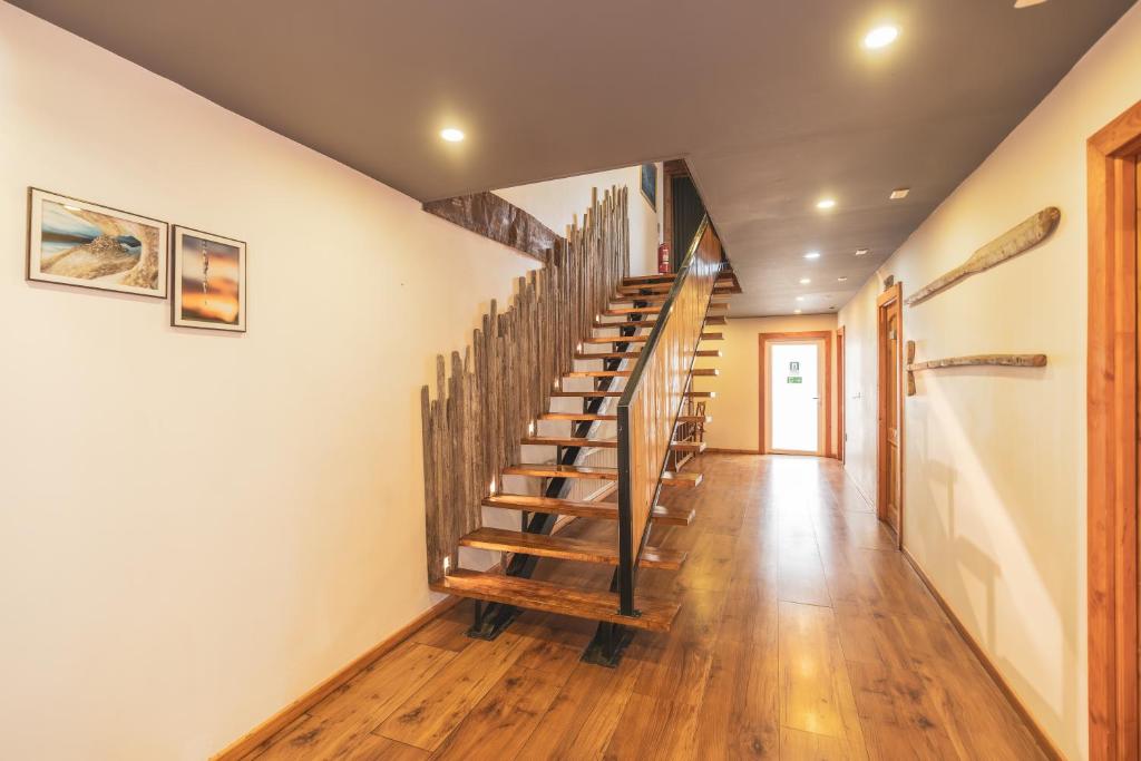 a staircase in a house with wooden floors at Pristine Patagonia Hotel in Puerto Natales