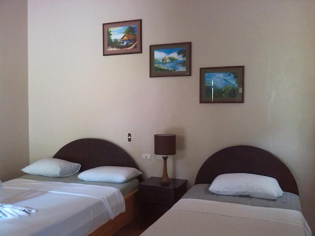 Ліжко або ліжка в номері Hotel Vista al Tortuguero