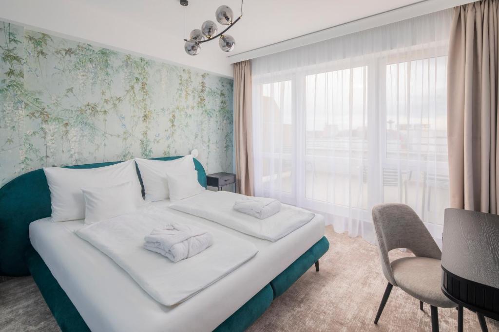 Postel nebo postele na pokoji v ubytování Hotel Atlantis Wellness & Conference