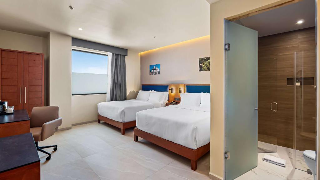Postel nebo postele na pokoji v ubytování Hampton By Hilton Queretaro Juriquilla
