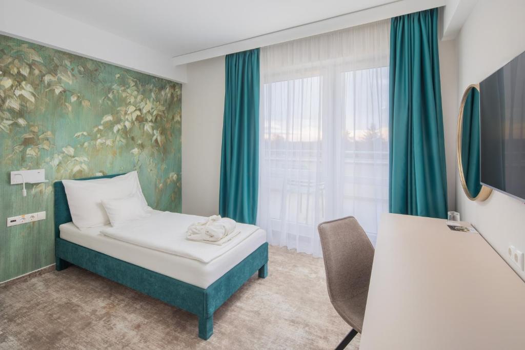 Postel nebo postele na pokoji v ubytování Hotel Atlantis Wellness & Conference