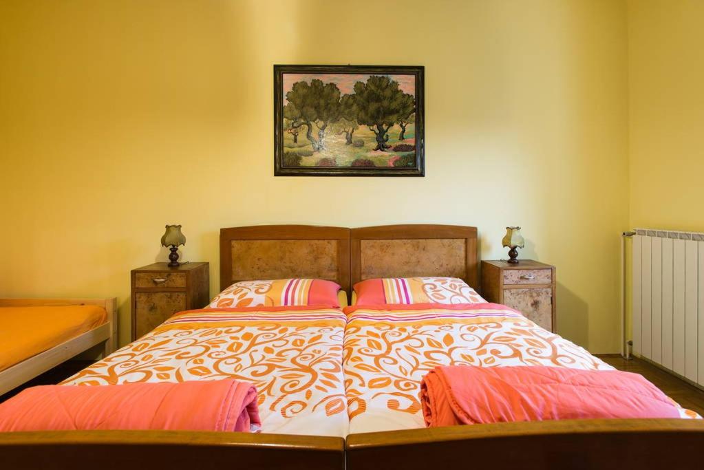 a bedroom with a large bed with two pillows at Apartment Luna in Osp