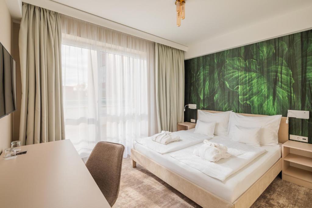 Postel nebo postele na pokoji v ubytování Hotel Atlantis Wellness & Conference