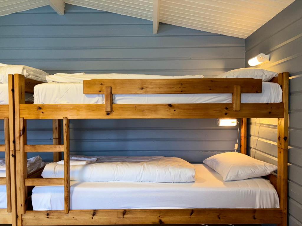 two bunk beds in a room with a blue wall at Winjum Cabin Aurland Stegastein in Aurland