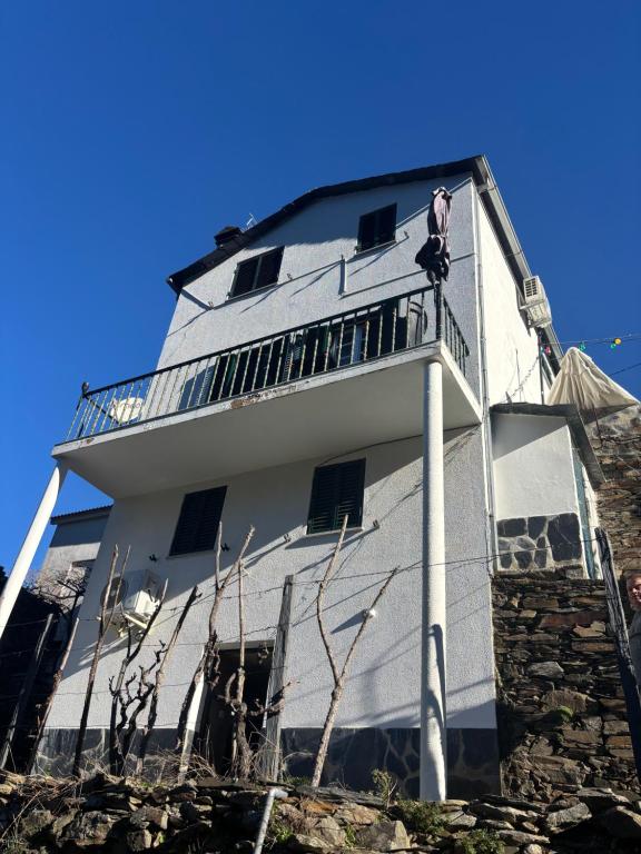 a man standing on the balcony of a building at White House in Piódão