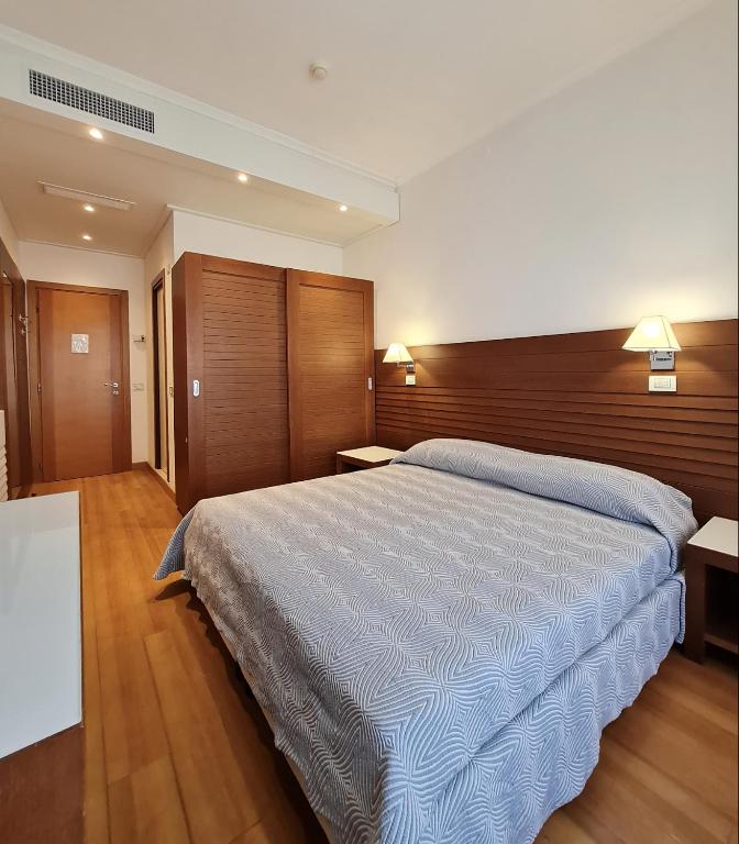 A bed or beds in a room at Club Hotel