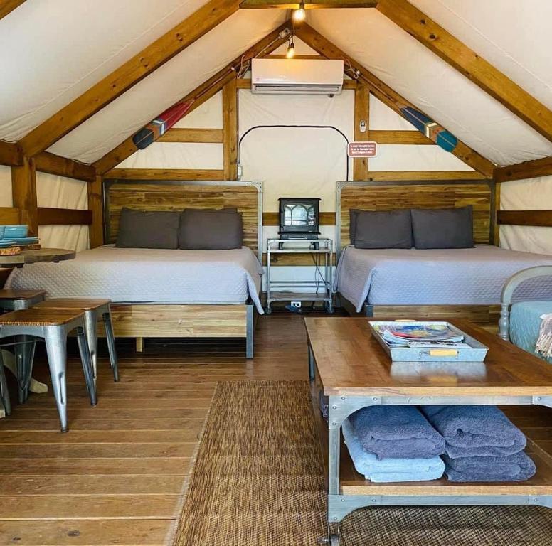 a room with two beds and a table at Safari Cabin A in Seguin