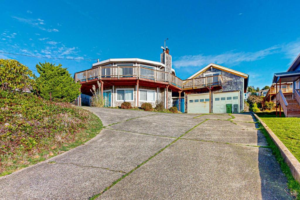 a large house with a driveway in front of it at Carousel House in Pacific City in Pacific City