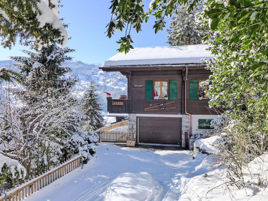 a cabin in the snow with snow covered trees at Holiday Home Chalet Tannengüetli by Interhome in Grindelwald