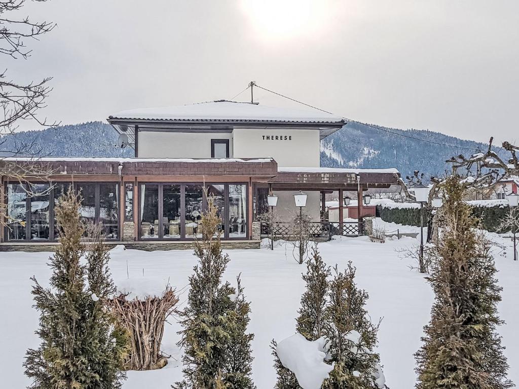 a building in the snow with trees in front of it at Apartment Villa Therese by Interhome in Moosburg