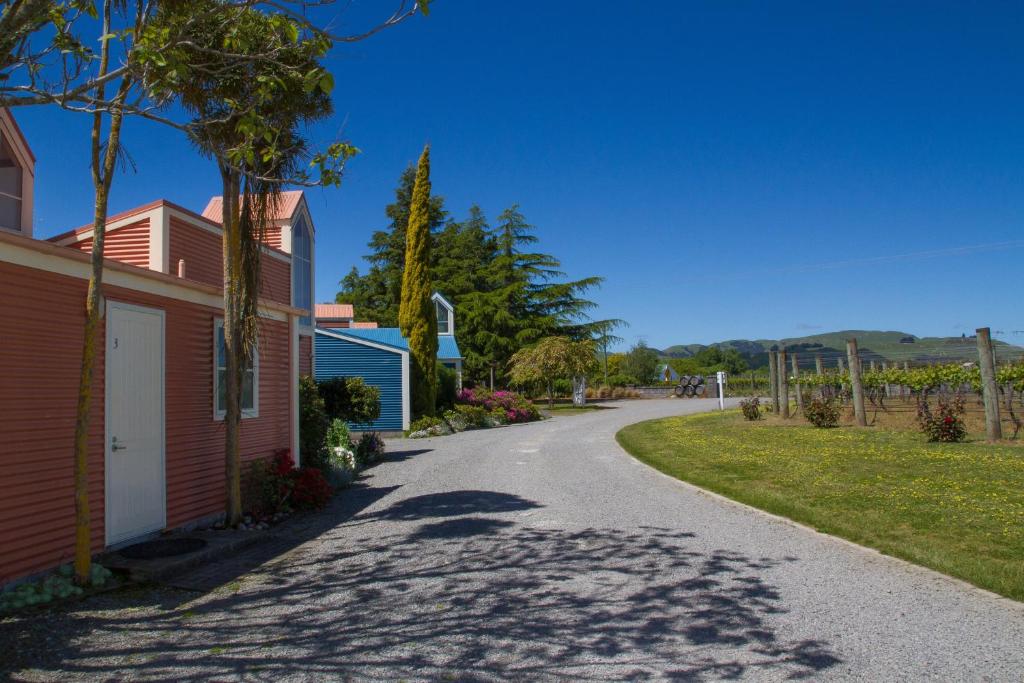 a road next to a building and a house at Margrain Vineyard Villas in Martinborough 