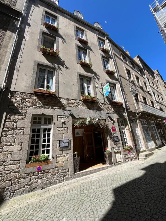 a large stone building with windows and plants on it at Hotel des Abers in Saint Malo