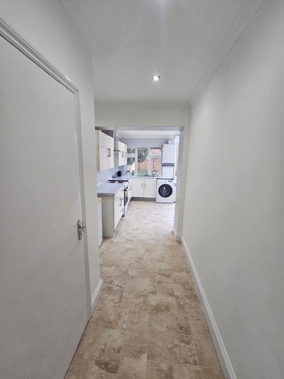 an empty room with a hallway with a kitchen at Mirandas Place in Gillingham