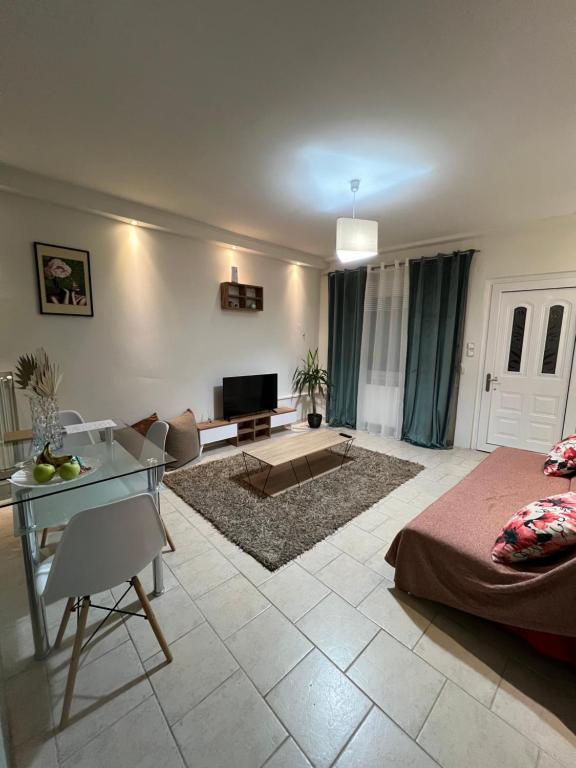 a living room with a bed and a table at John & Jo Apartment! in Kastoria