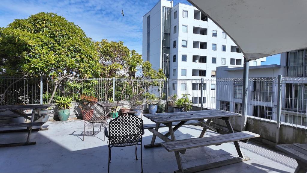 un tavolo da picnic con sedie su un balcone con un edificio di United Auckland ad Auckland