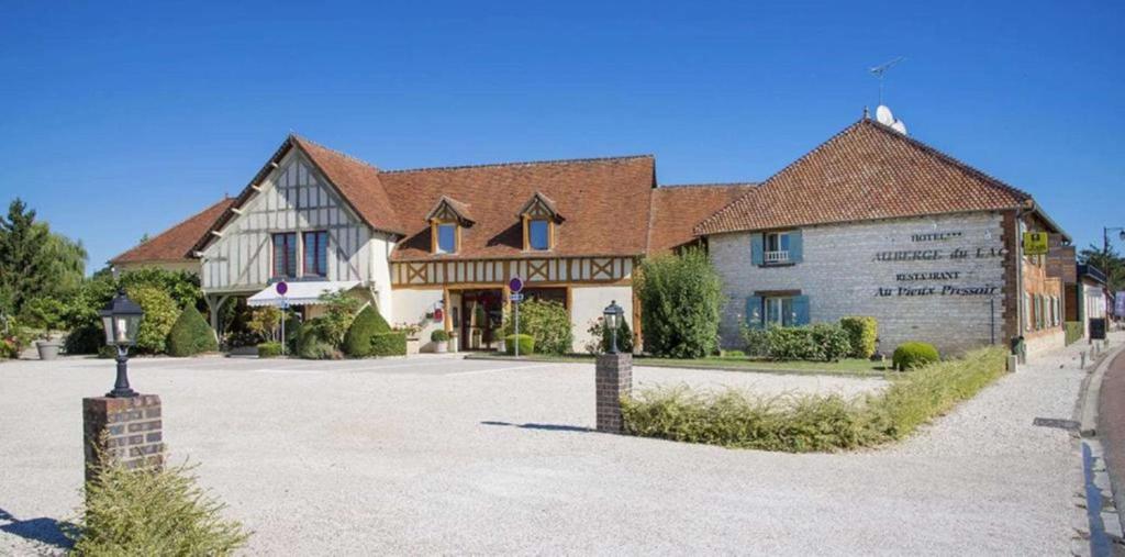 a large building with a large driveway in front of it at Auberge du Lac, Sure Hotel Collection by Best Western in Mesnil-Saint-Père