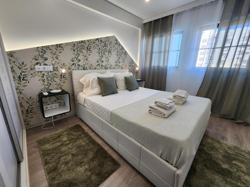 a bedroom with a large bed and a window at Ria Center Apartment - Right in Faro