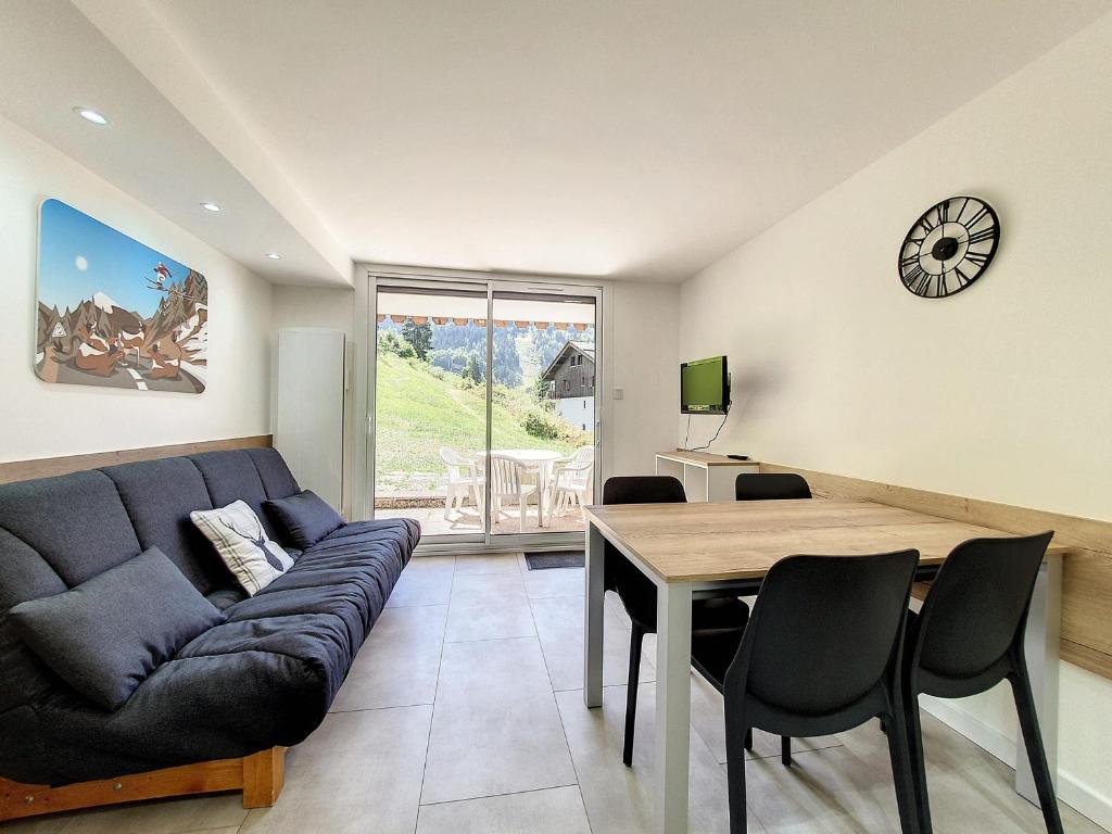 un salon avec un canapé et une table dans l'établissement Studio cosy La Clusaz 4 pers, terrasse, WiFi, garage - FR-1-818-62, à La Clusaz