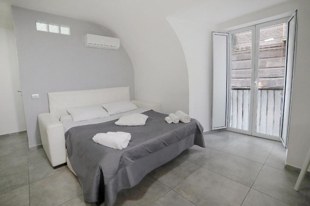 a bedroom with a bed with two towels on it at Casa Sant Anna in Naples