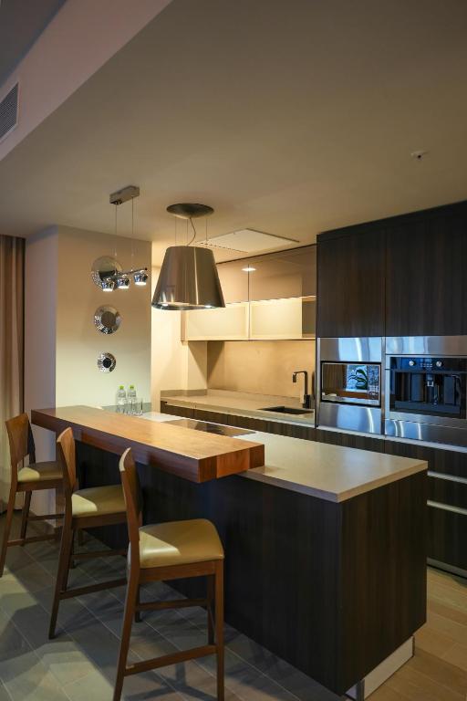 a kitchen with a large island in the middle at Metria Hotel in León
