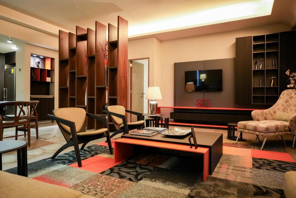 a living room filled with furniture and a tv at Metria Hotel in León