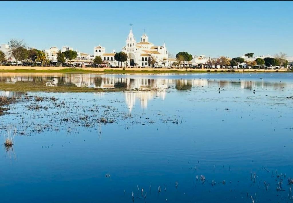 a large body of water with buildings in the background at Puente del Rey, El Rocio Deluxe in El Rocío