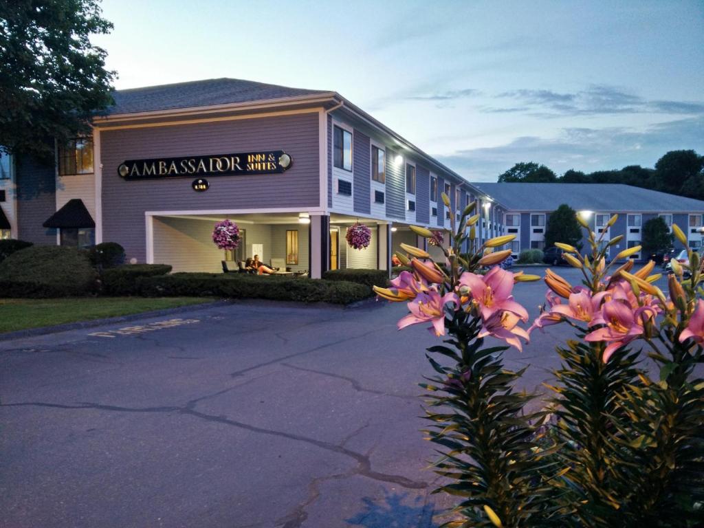 a building with a sign on the side of it at Ambassador Inn and Suites in South Yarmouth