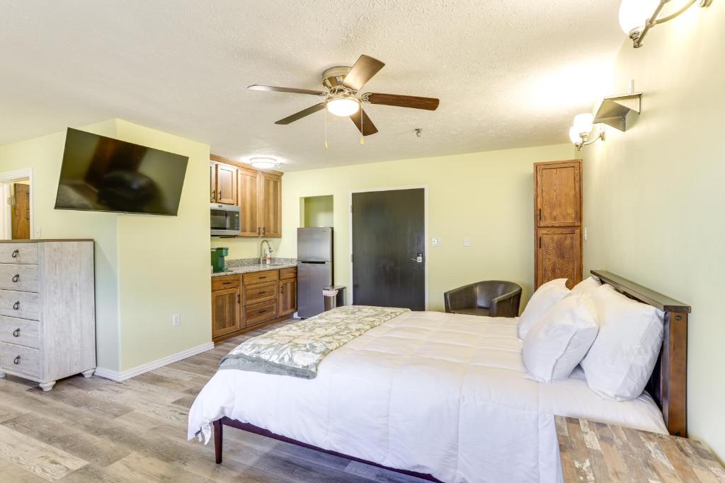 a bedroom with a bed and a ceiling fan at Quiet Oakland City Studio Walk Downtown! in Oakland City