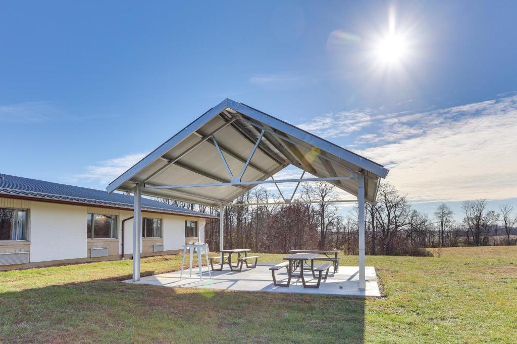 a pavilion with two picnic tables in a field at Less Than 1 Mi to Oakland City University Cozy Apartment in Oakland City