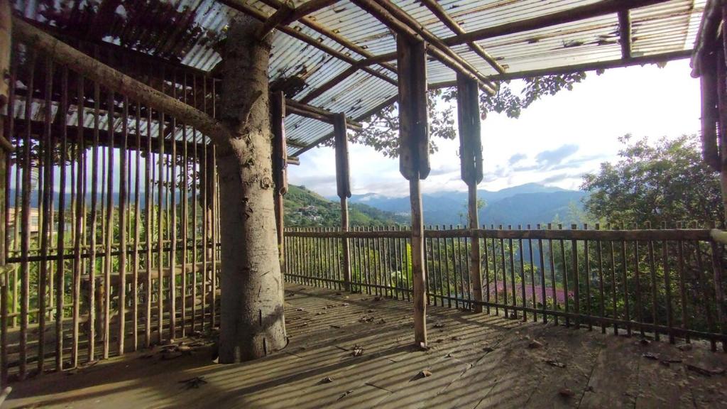 a porch with a fence and a view of the mountains at country estate in Pasto