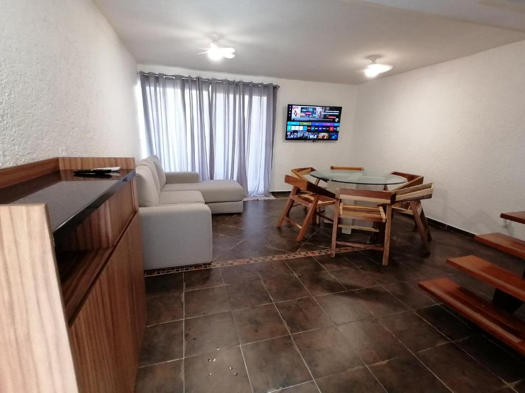 un salon avec un canapé et une table à manger dans l'établissement VILLA ACAPULCO DIAMANTE, à Acapulco