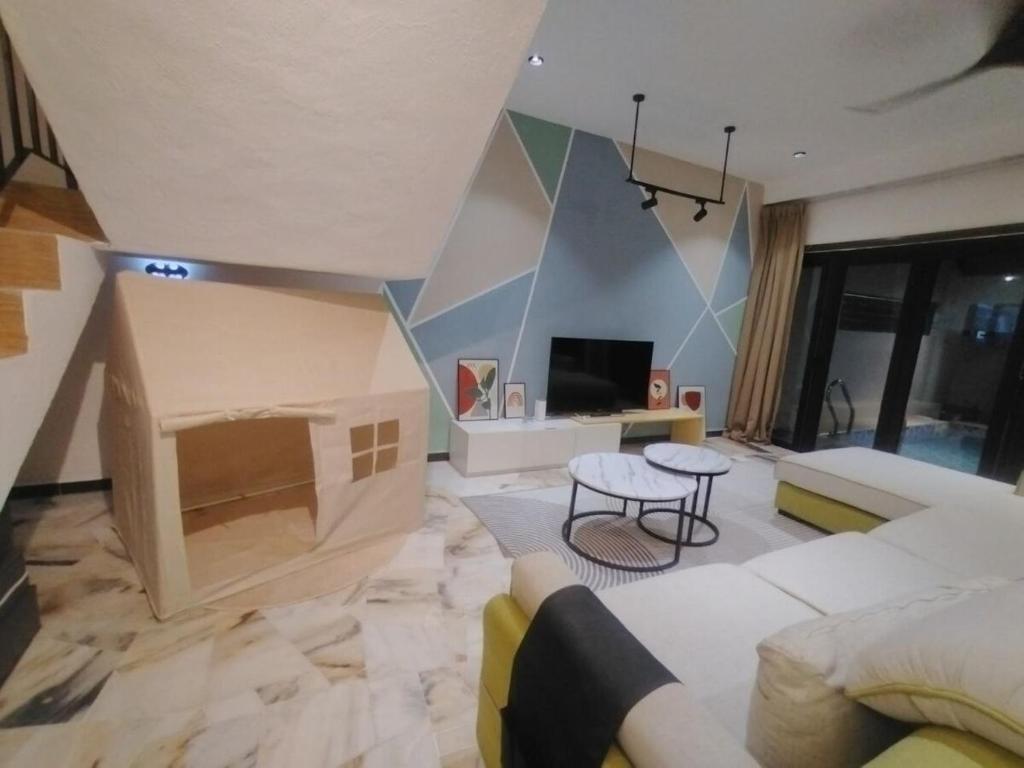 a living room with a couch and a fireplace at D Laman Santai 17Pax 5R4B Near TC Beach in Kuantan
