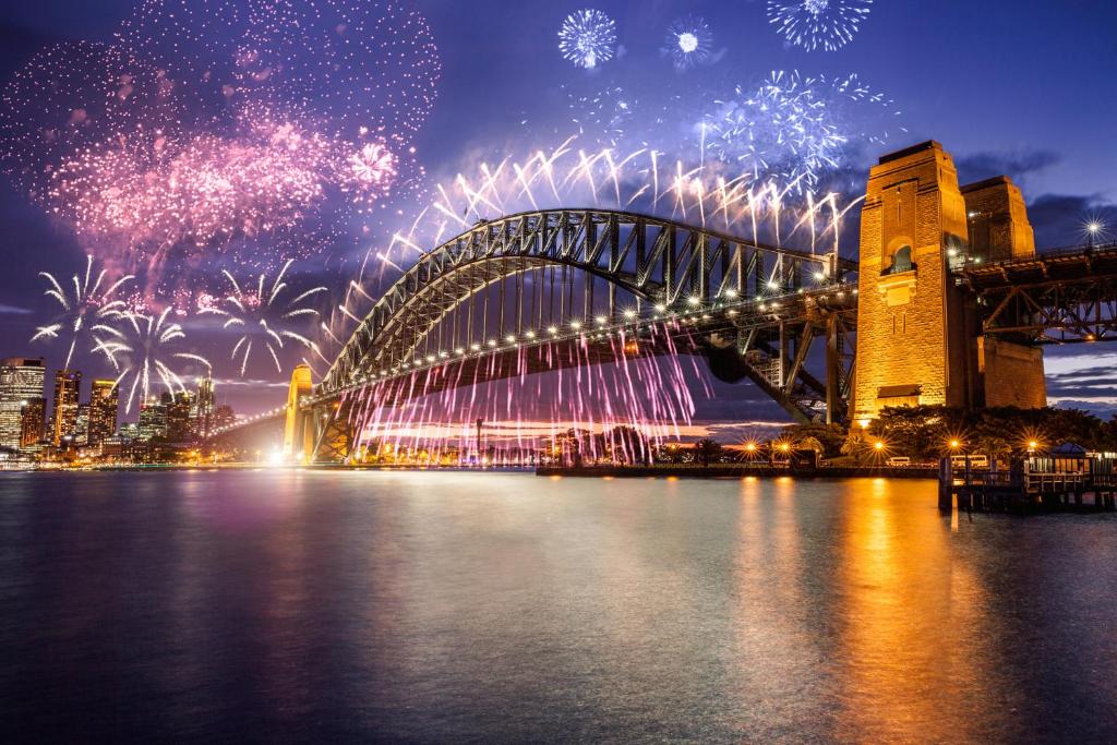 a sydney harbour bridge with fireworks in the sky at Breathtaking Sydney Harbour view condo in Sydney