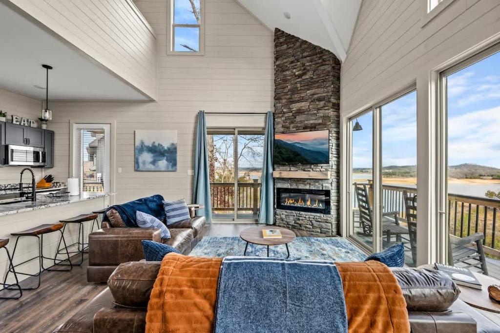 a living room with a couch and a fireplace at Mountain Lake Escape in Dandridge