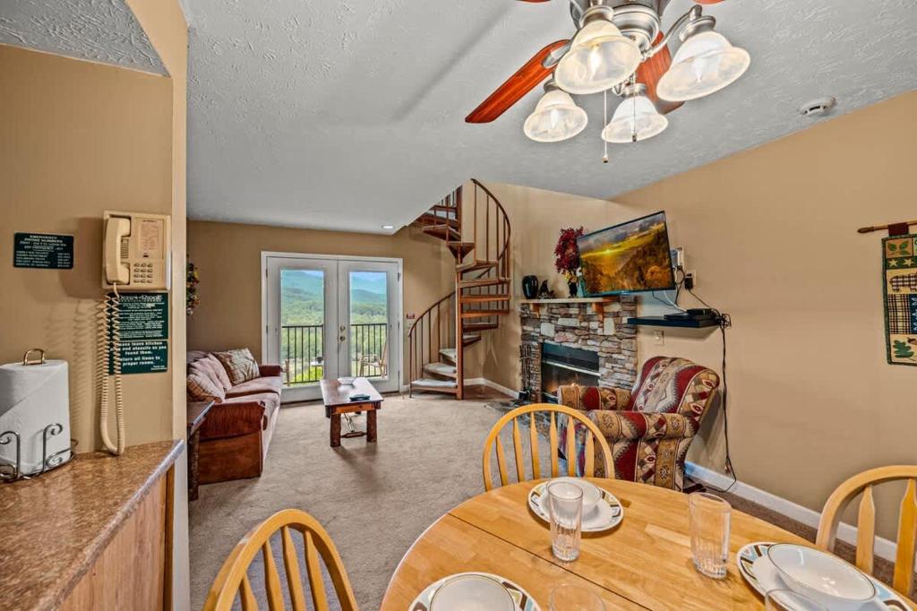 a kitchen and living room with a table and chairs at Rocky Top Oasis in Gatlinburg