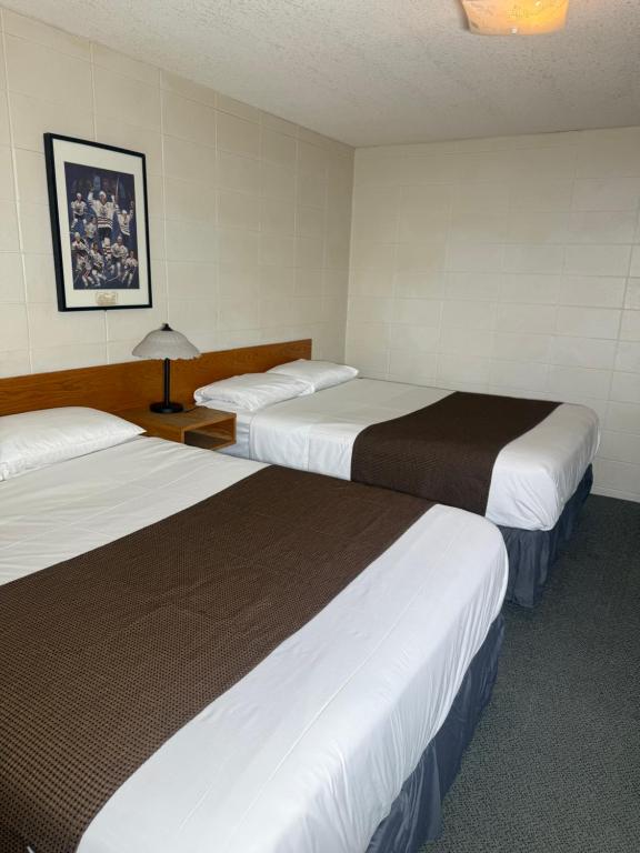 Postel nebo postele na pokoji v ubytování Sunrise Motel
