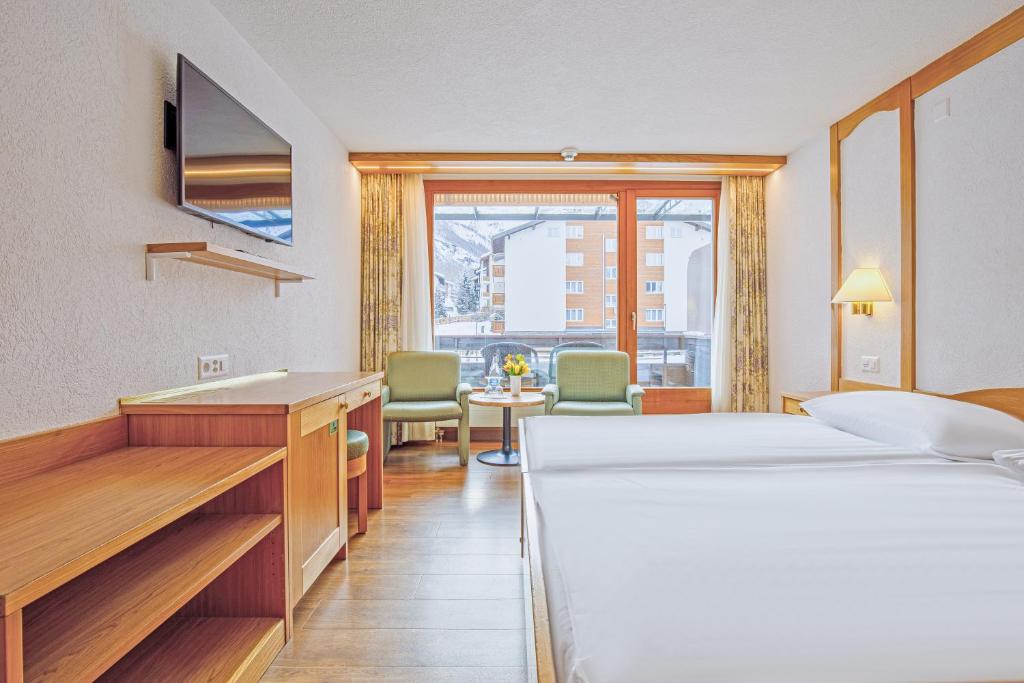 Postel nebo postele na pokoji v ubytování Hotel Alpin Superior