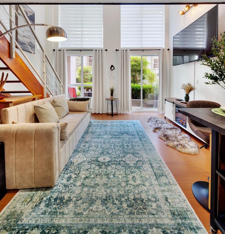 a living room with a couch and a rug at Stylish Two-Story Loft with Rooftop Deck in Vancouver