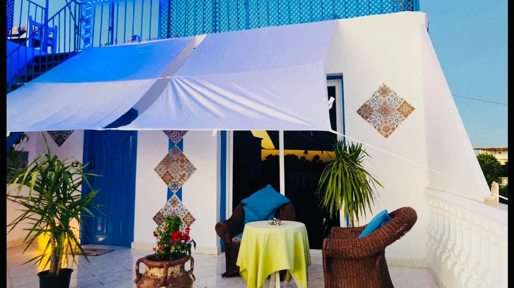 a room with a table and chairs and a building at Roses House Ladies or families only in Luxor