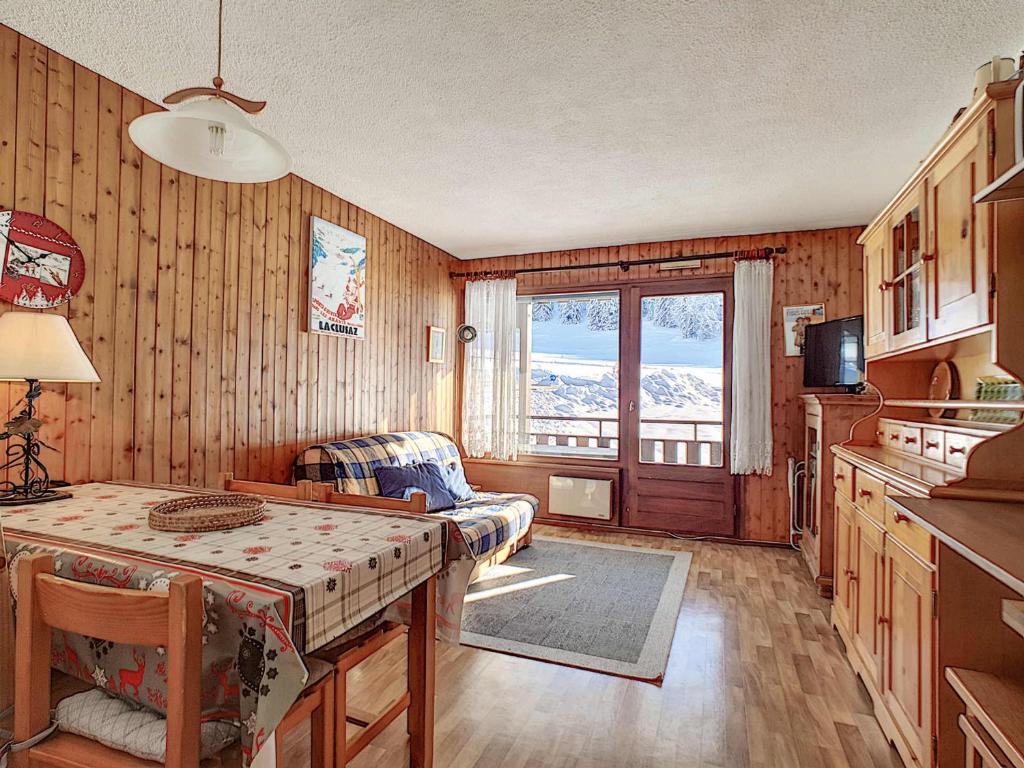 une cuisine et un salon avec une table et un canapé dans l'établissement Studio cosy à La Clusaz avec balcon et garage, animaux admis - FR-1-818-9, à La Clusaz