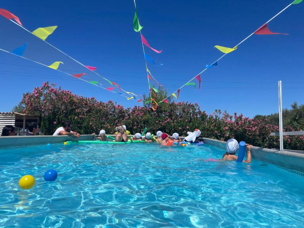 a group of people playing in a swimming pool at La Villa del Conte in Scicli