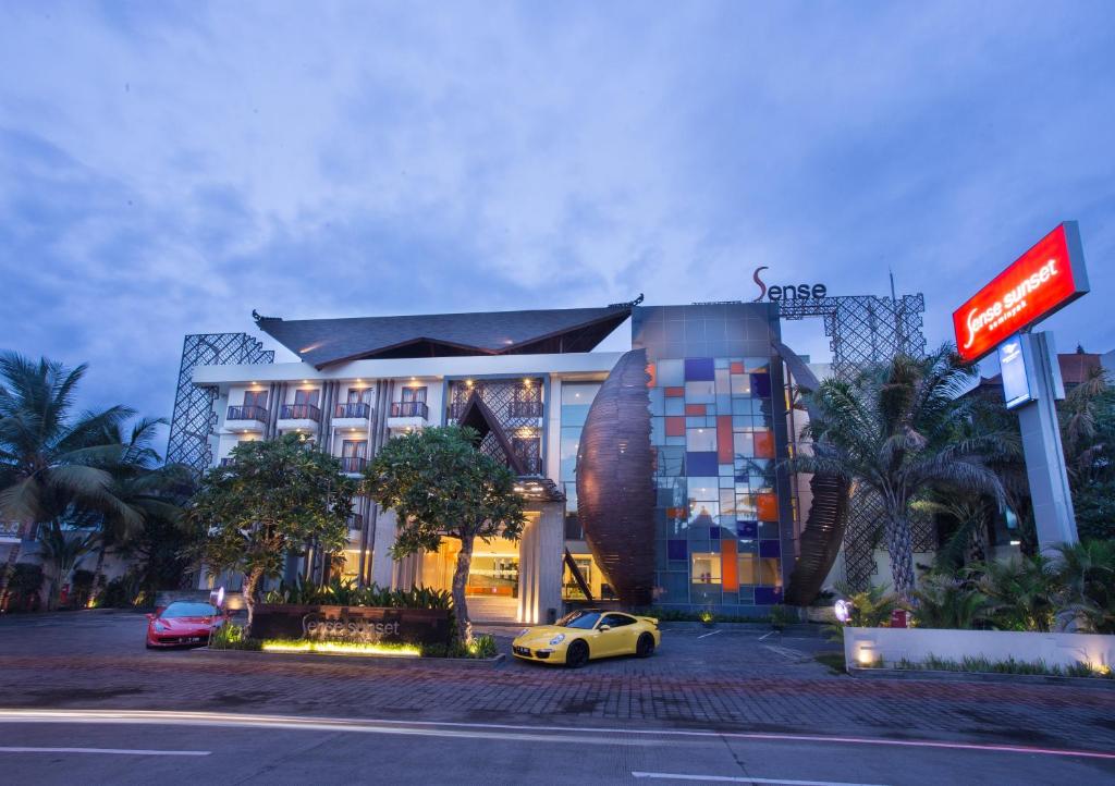 a hotel with a car parked in front of it at Sense Sunset Hotel Seminyak in Seminyak