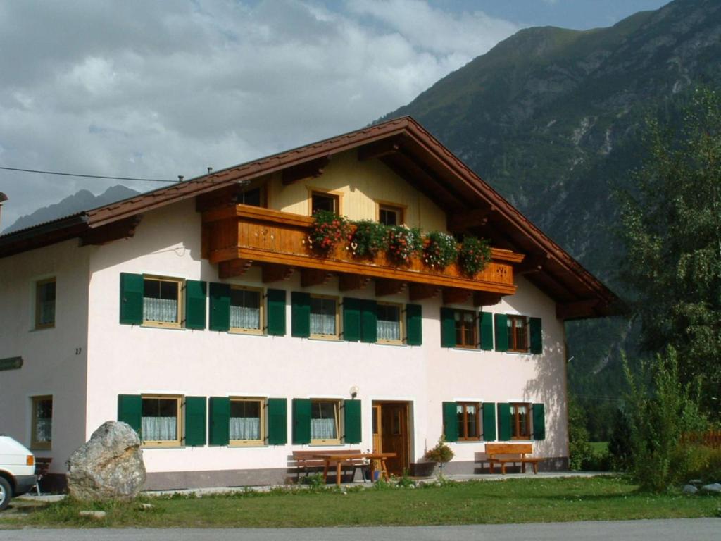 a building with a balcony with plants on it at Haus Dietmar in Holzgau